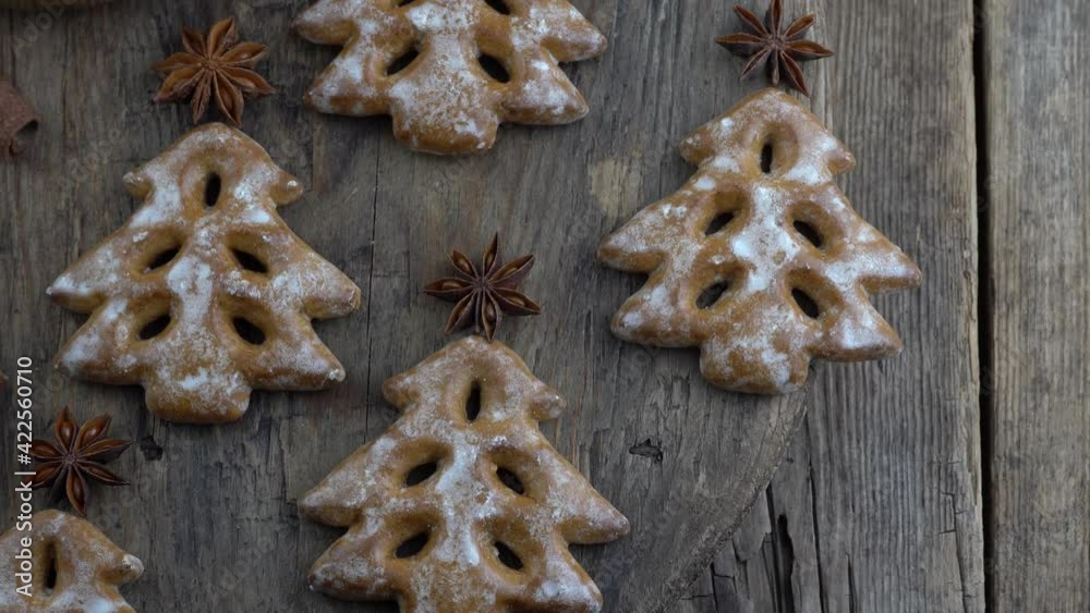 Christmas tree cookies on wooden background. New Year's food. Anise star. Festive baked goods. Gingerbread on the table.Icing sugar sweetness taste season. Christmas tree cookies on wooden background. New Year's food. Anise star. Festive baked goods. Gingerbread on the table.Icing sugar sweetness taste season.