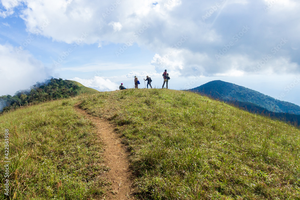 Obraz premium People or traveler walk on the Mountain hill with grass field with sea of fog or white clouds at 