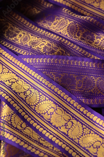 Purple violet Indian Sari border with gold paisley pattern. purple background