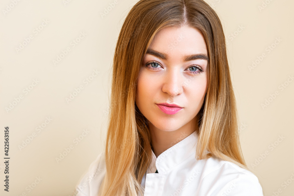 Portrait of beautiful young caucasian businesswoman looking at camera against a light yellow background Portrait of beautiful young caucasian businesswoman looking at camera against a light yellow background