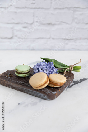 hyacinth and macaroons on a wooden background