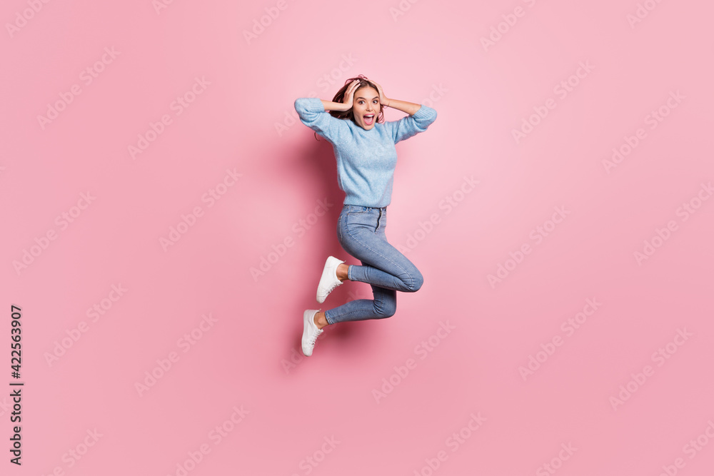 Full length body size view of attractive amazed cheerful girl jumping having fun good news isolated over pink pastel color background Full length body size view of attractive amazed cheerful girl jumping having fun good news isolated over pink pastel color background