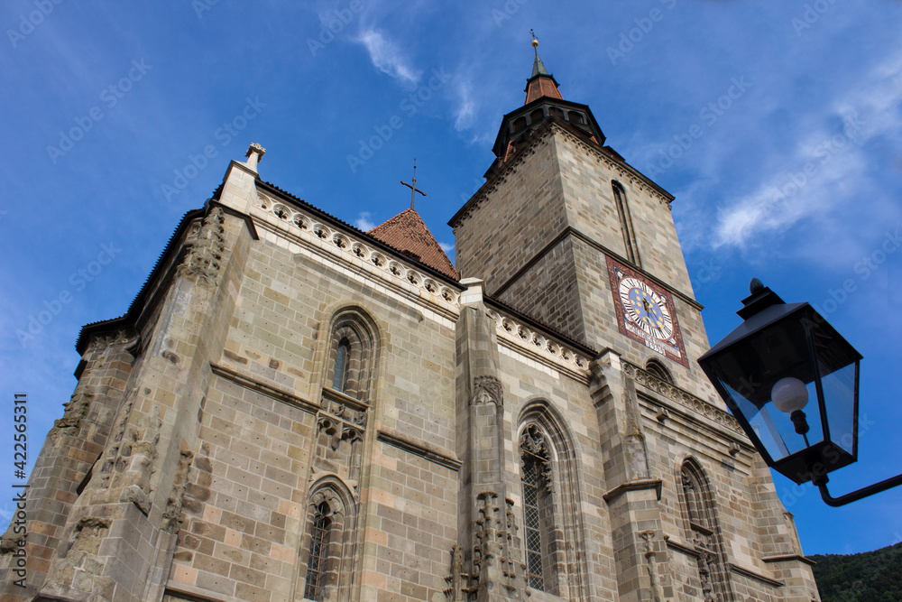 Low angle view of Black Church clock tower from Brasov, Romania with clear blue sky Low angle view of Black Church clock tower from Brasov, Romania with clear blue sky