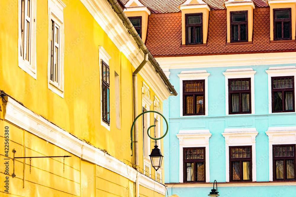 Two colourful building of historical center during sunny day 