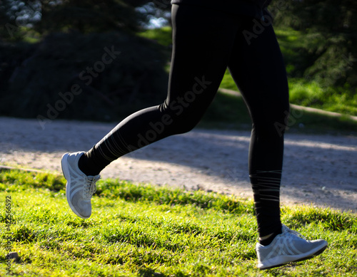 Young woman jogging in a park in the morning.