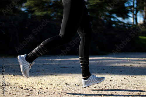 Young woman running in a park. Active person. Health and sport.