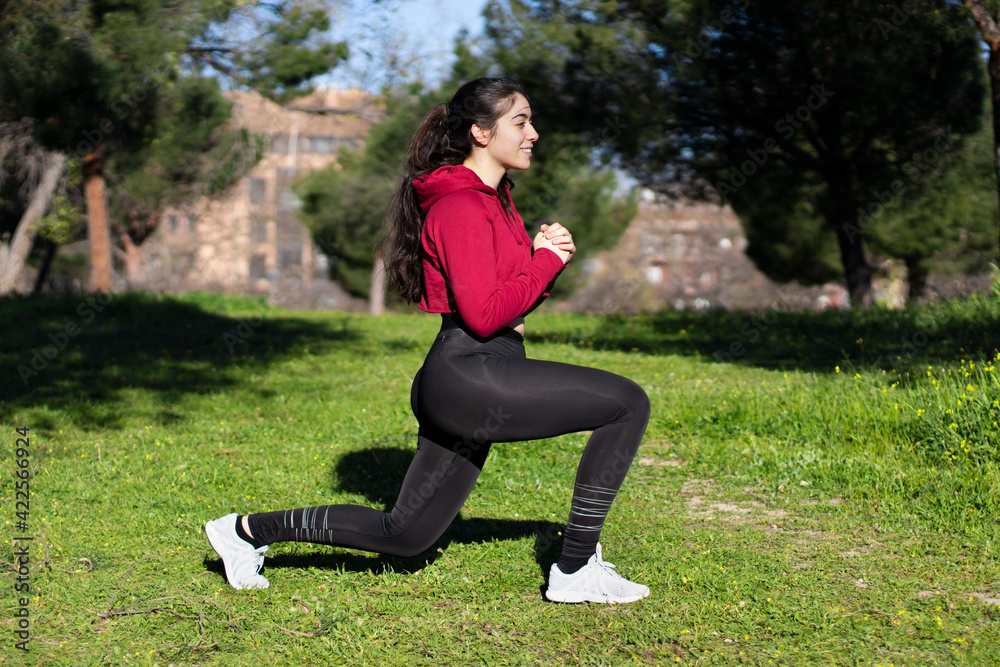 Young woman doing lunches in a park. training and health Young woman doing lunches in a park. training and health