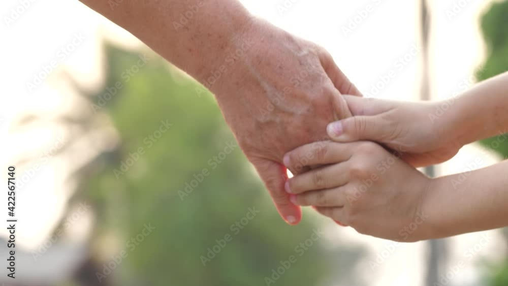 Close-up of hands joining together with sunlight Close-up of hands joining together with sunlight
