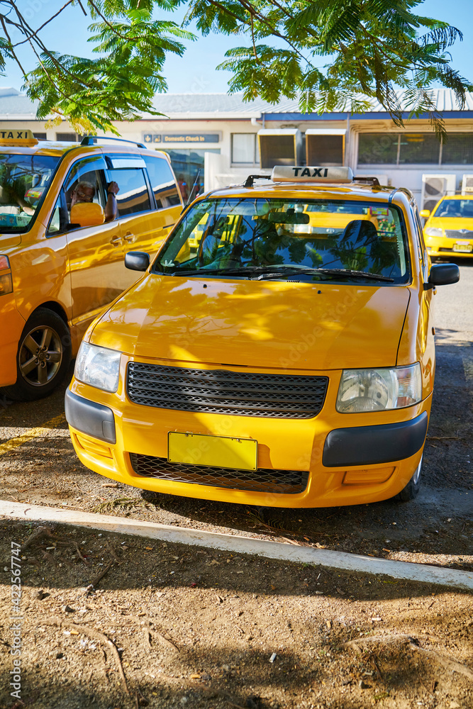 Obraz premium A parked yellow taxi in Fiji.