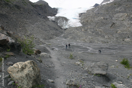 People Walking Toward Worthington Glacier Terminus, Alaska, to Explore the End Moraine and the Glacial Delta Near Valdez, Alaska with the Glacial Stream and Delta below the Glacier photo