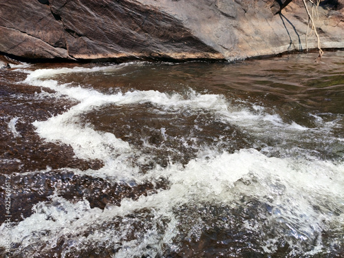 Close up view - the flow of water from a stone
