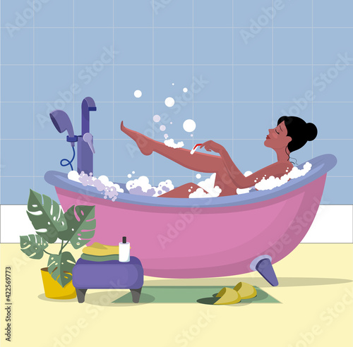 The girl in the bathroom. A brunette girl shaves her legs in a bubble bath. Bathroom, interior detail, design element, layout.