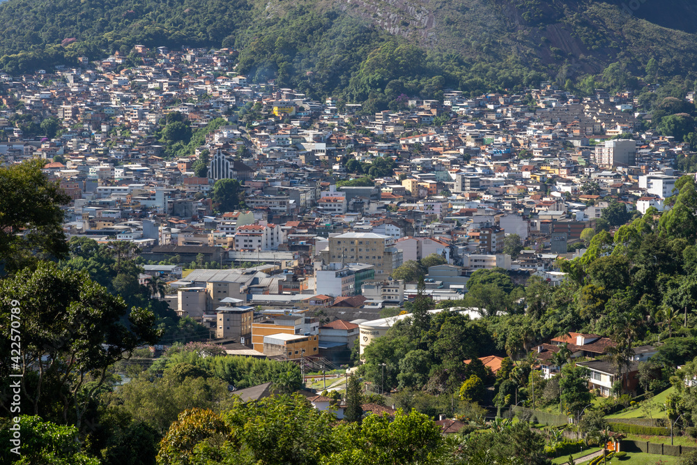 Part of the city of Nova Friburgo next to a giant rock and nature in the surroundings seen from above. Rio de Janeiro, Brazil.