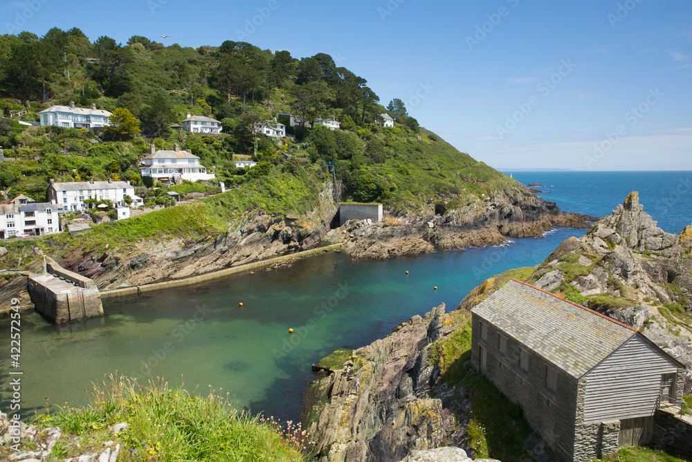 Entrance Polperro harbour Cornwall UK with clear blue green sea 
