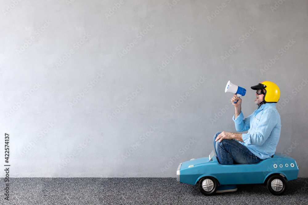 Fototapeta premium Senior businessman against concrete wall with copy space