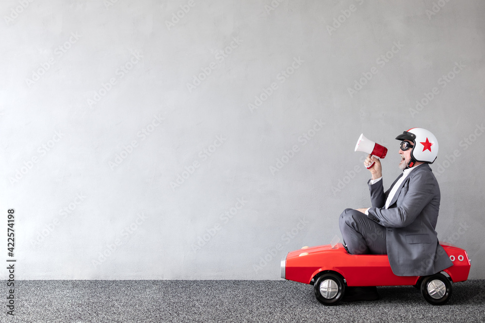 Senior businessman against concrete wall with copy space