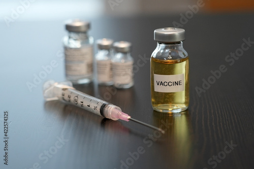 A shot of a generic vaccination vial and needle.