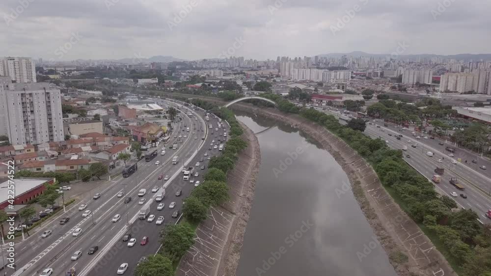 Aerial drone view of the Marginal Tietê Avenue car traffic, Tiete River and beautiful São Paulo city skyline on cloudy day. Concept of urban landscape, travel, cityscape, co2, pollution, metropolis. Aerial drone view of the Marginal Tietê Avenue car traffic, Tiete River and beautiful São Paulo city skyline on cloudy day. Concept of urban landscape, travel, cityscape, co2, pollution, metropolis.