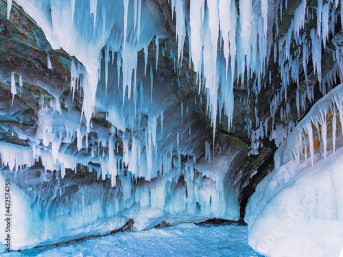 Winter Baikal. The fantastic beauty of the grottoes  framed by numerous transparent icicles. Natural winter background