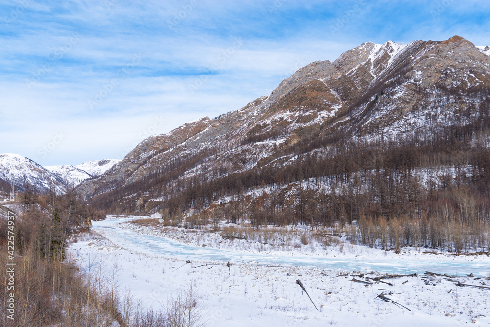 Winter landscape. Valley of the Irkut mountain river in early spring. Republic of Buryatia, Russia, Siberia