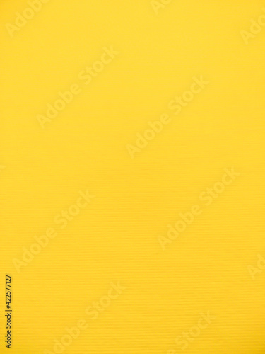 Texture of yellow watercolor paper. Surface of the drawing paper. Wall with yellow gradient with copy space.