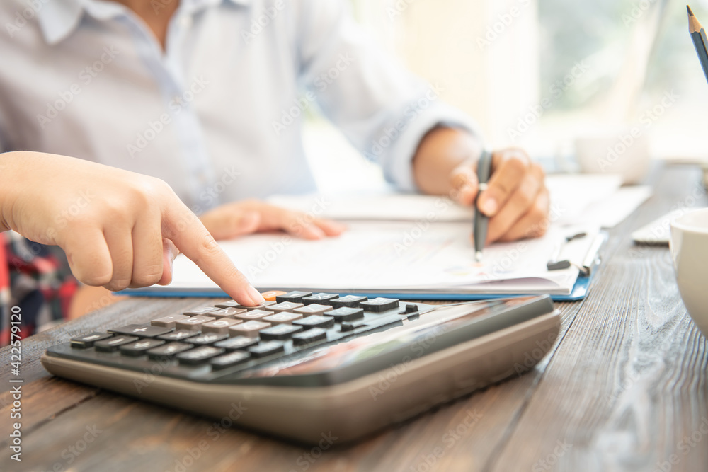 Administrator business man financial inspector and secretary making report, calculating balance. Internal Revenue Service checking document. Audit concept Administrator business man financial inspector and secretary making report, calculating balance. Internal Revenue Service checking document. Audit concept