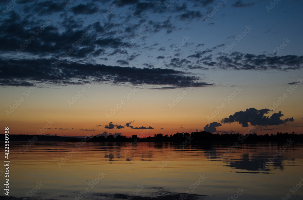 Sunset. Orange sky. Reflection in the river. Horizon