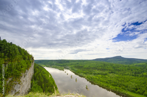 view from a high cliff to the river and the forest panorama