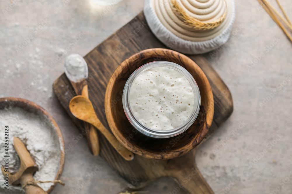 The leaven for bread is active. Starter sourdough ( fermented mixture of water and flour to use as leaven for bread baking). The concept of a healthy diet The leaven for bread is active. Starter sourdough ( fermented mixture of water and flour to use as leaven for bread baking). The concept of a healthy diet