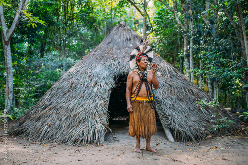 Cuadro en lienzo Shaman of the Pataxó tribe, wearing feather headdress and smoking a pipe