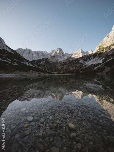 Sunset mirror reflection panorama in clear calm transparent alpine mountain lake Seebensee in Ehrwald Tyrol Austria alps photo