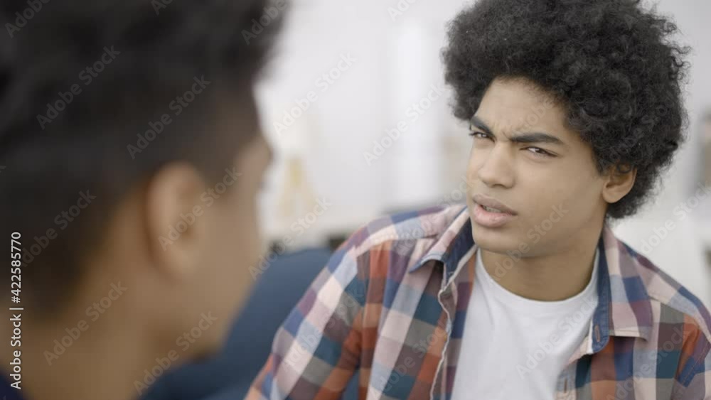 Mixed-race teen friends talking, sharing opinions, discussing common interests