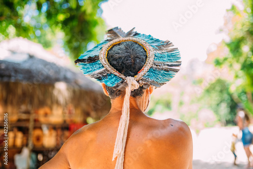 Indian from the Pataxó tribe, with feather headdress. Elderly Brazilian Indian with his back to the camera photo