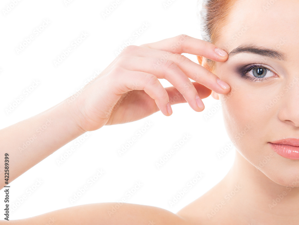 Portrait of beautiful calm woman with young clean healthy skin holding hand near eye, studio shot isolated on white background. Anti-aging and beauty treatment, vision concept.