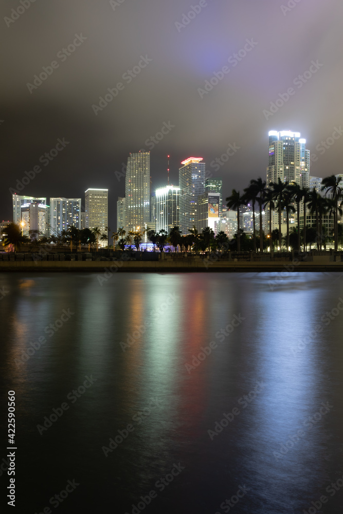 Fototapeta premium city skyline at night, miami florida, biscayne bay, long exposure, clouds