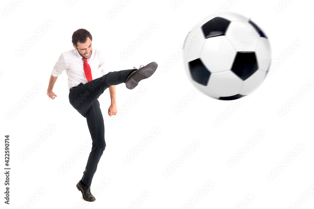 Businessman kicking a football