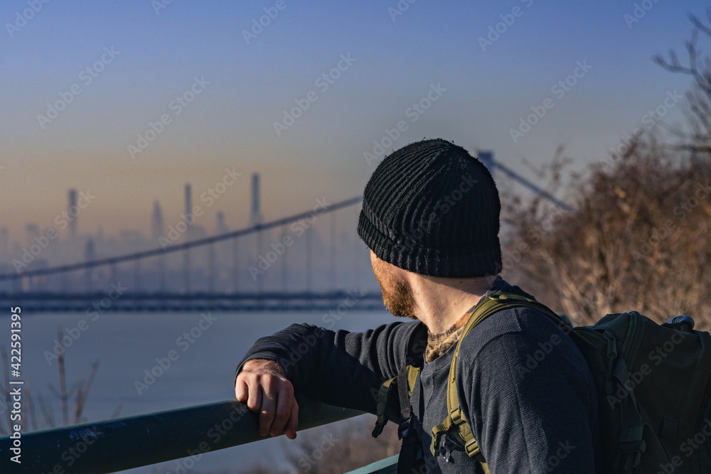 Man hiker looking at Nyc skyline from New Jersey Man hiker looking at Nyc skyline from New Jersey
