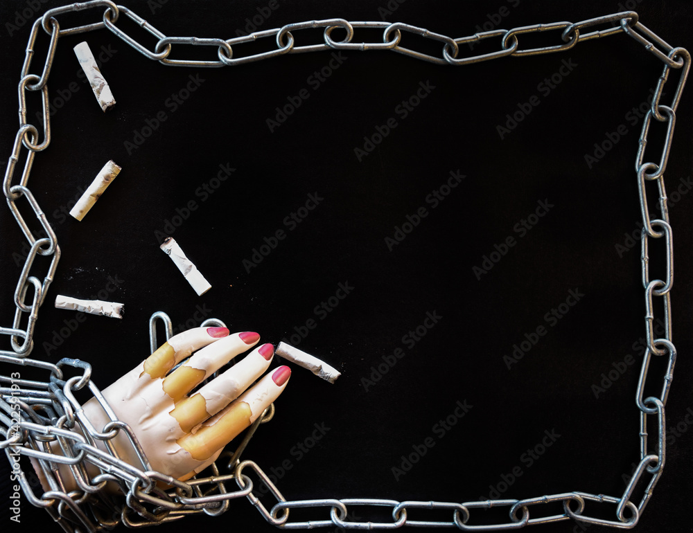 Concept With Mannequin Hand In Chains Depicting The Bondage Of Smoking concept-with-mannequin-hand-in-chains-depicting-the-bondage-of-smoking