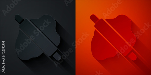 Paper cut Rolling pin on dough icon isolated on black and red background. Paper art style. Vector