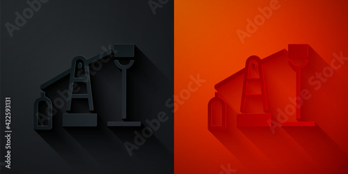 Paper cut Oil pump or pump jack icon isolated on black and red background. Oil rig. Paper art style. Vector