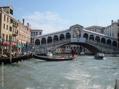 Venice old city grand canal with gondolas and boats. Romantic swimming in the morning. Comfotrable transportation to ancient historic hotel. Scenic Venetian scape on a sunny day. © Liudmyla Leshchynets