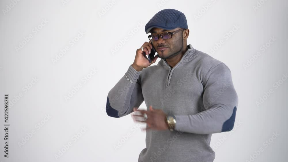 African man talking on mobile phone. Young african guy talking by cell phone in studio African man talking on mobile phone. Young african guy talking by cell phone in studio