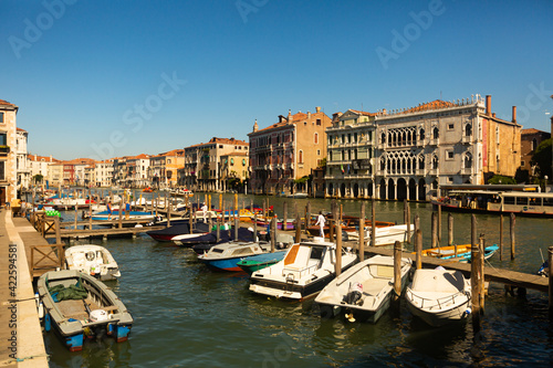VENICE, ITALY - SEPTEMBER 05, 2019: Motor boats parking in Grand Canal on background of impressive architecture of ancient buildings on banks of canal © JackF