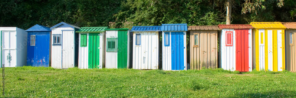 A line of colorful cabins on the beach A line of colorful cabins on the beach