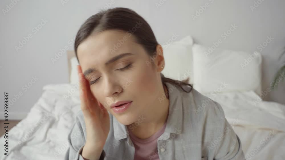 upset young woman with closed eyes suffering from headache upset young woman with closed eyes suffering from headache