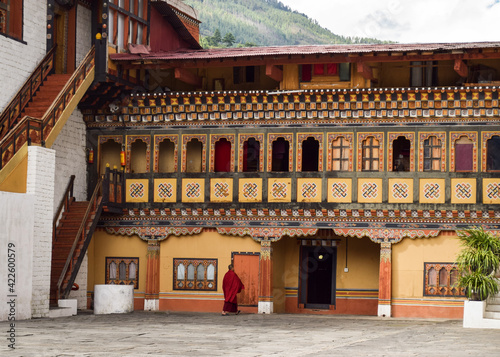 A monk in front of one of the buildings in Tashichho Dzong. Thimphu, Bhutan. photo