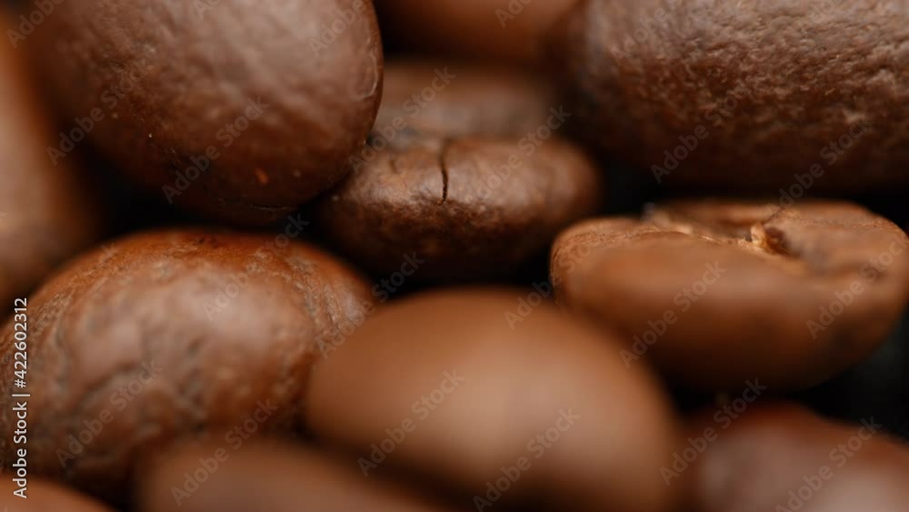 Roasting coffee beans. Close up in fragrant coffee beans smoking. Fragrant coffee beans being roasted. Coffee beans macro rotating Roasting coffee beans. Close up in fragrant coffee beans smoking. Fragrant coffee beans being roasted. Coffee beans macro rotating