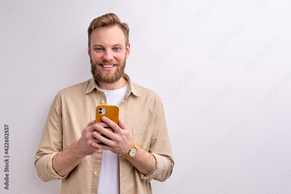 nice attractive young man holding mobile phone in hands creating social strategy influencer thinking nice attractive young man holding mobile phone in hands creating social strategy influencer thinking