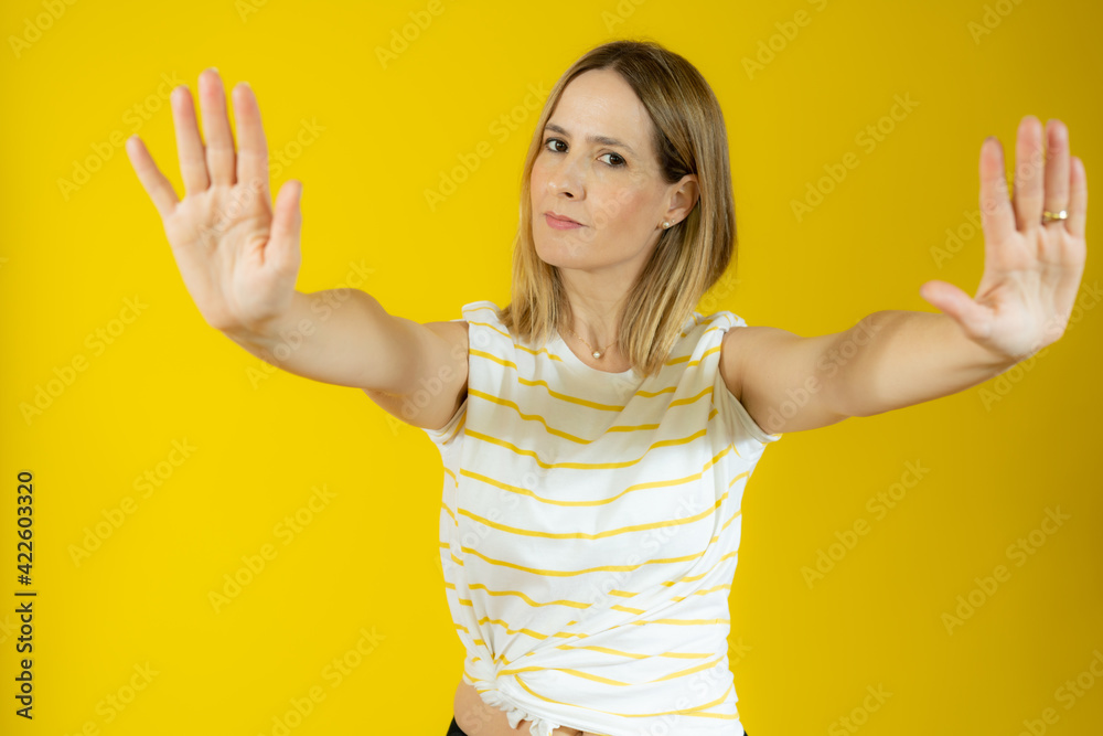 Beautiful caucasian woman doing stop gesture with palm of the hand. Beautiful caucasian woman doing stop gesture with palm of the hand.
