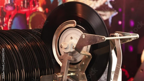 Fine shot Jukebox playing music from vinyl single record with old time classic mechanism.  photo